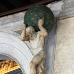 Statue of mythical figure holding globe